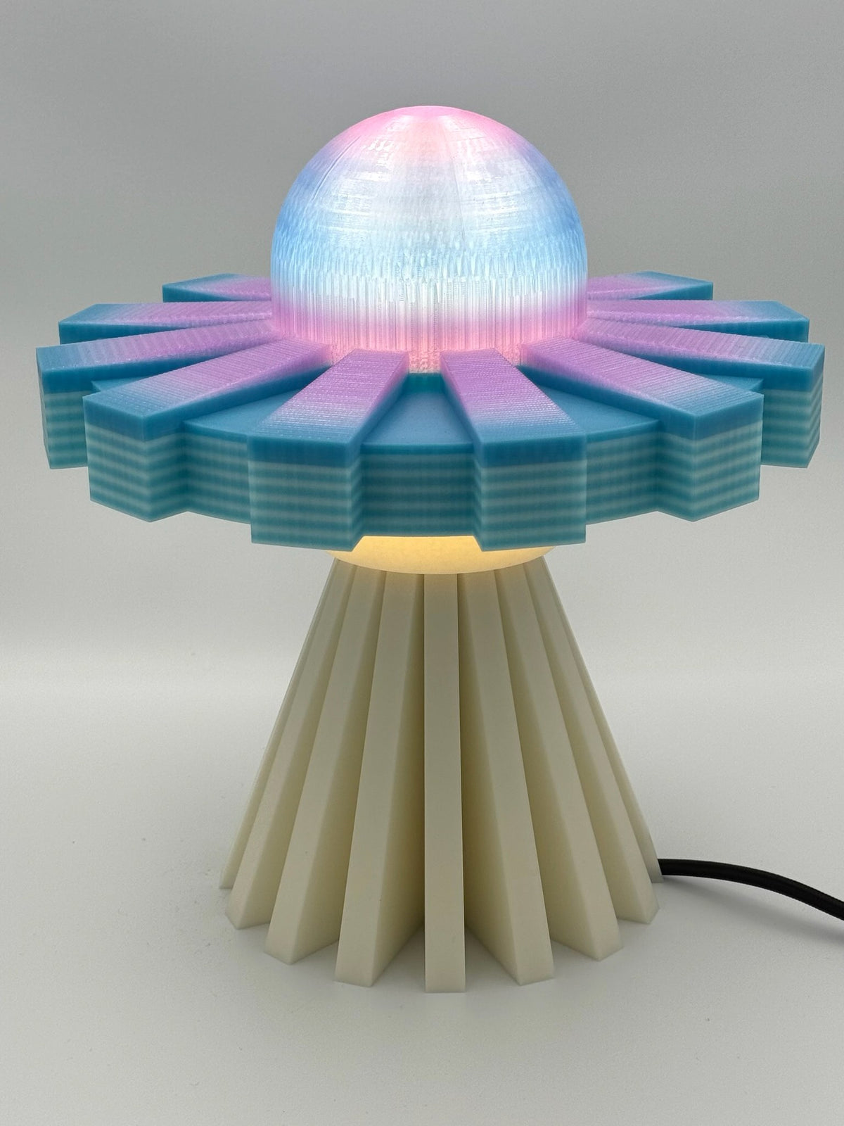 Cotton Candy and Cream UFO lamp switched on with glowing pink and blue dome