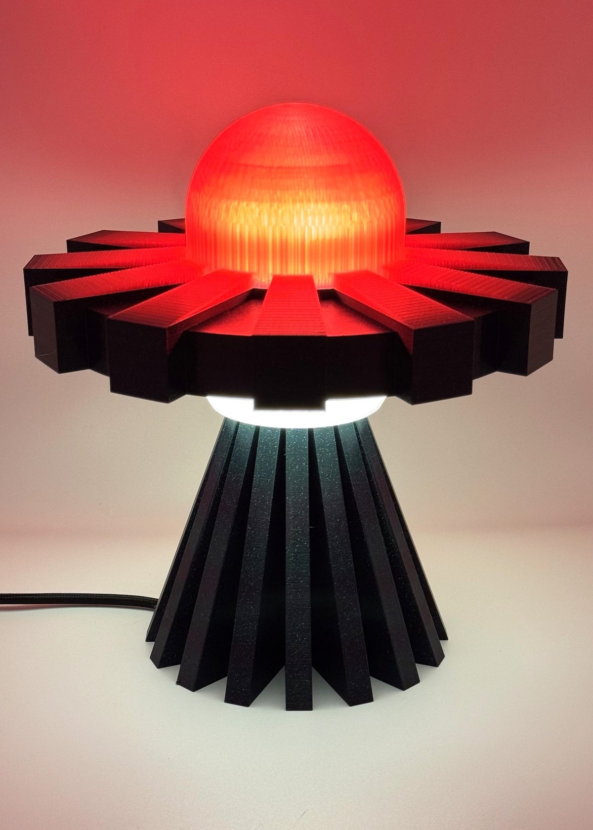 Red and black UFO lamp glowing red