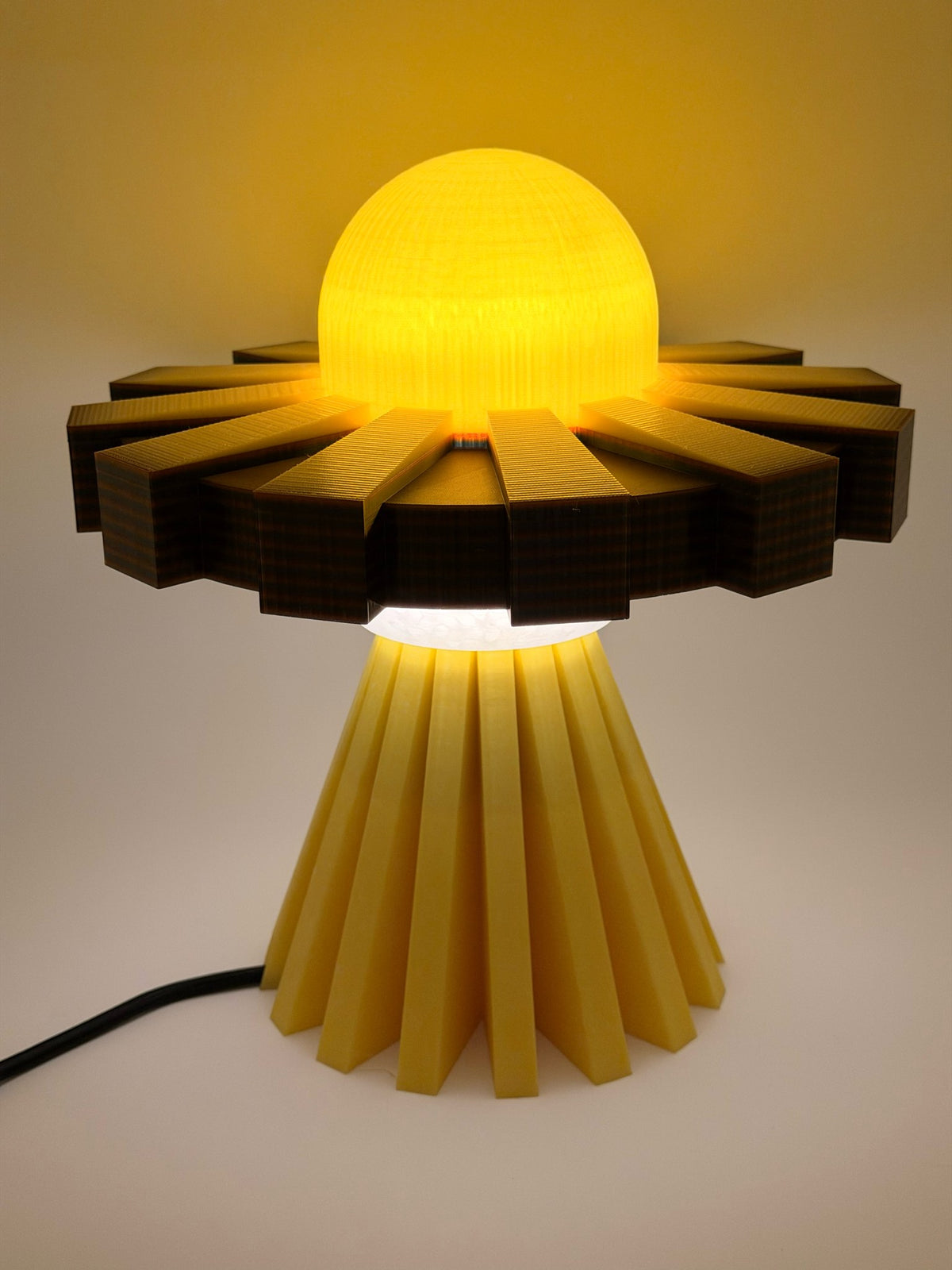 Golden yellow UFO lamp switched on, glowing warm amber