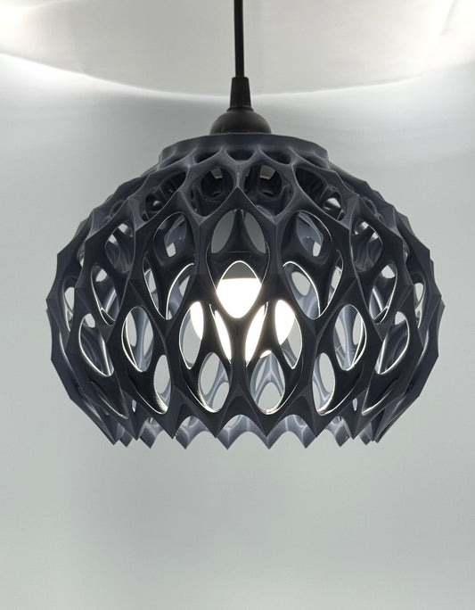 Gunmetal gray Alien Beehive 3D printed pendant lamp lit, with honeycomb lattice dome