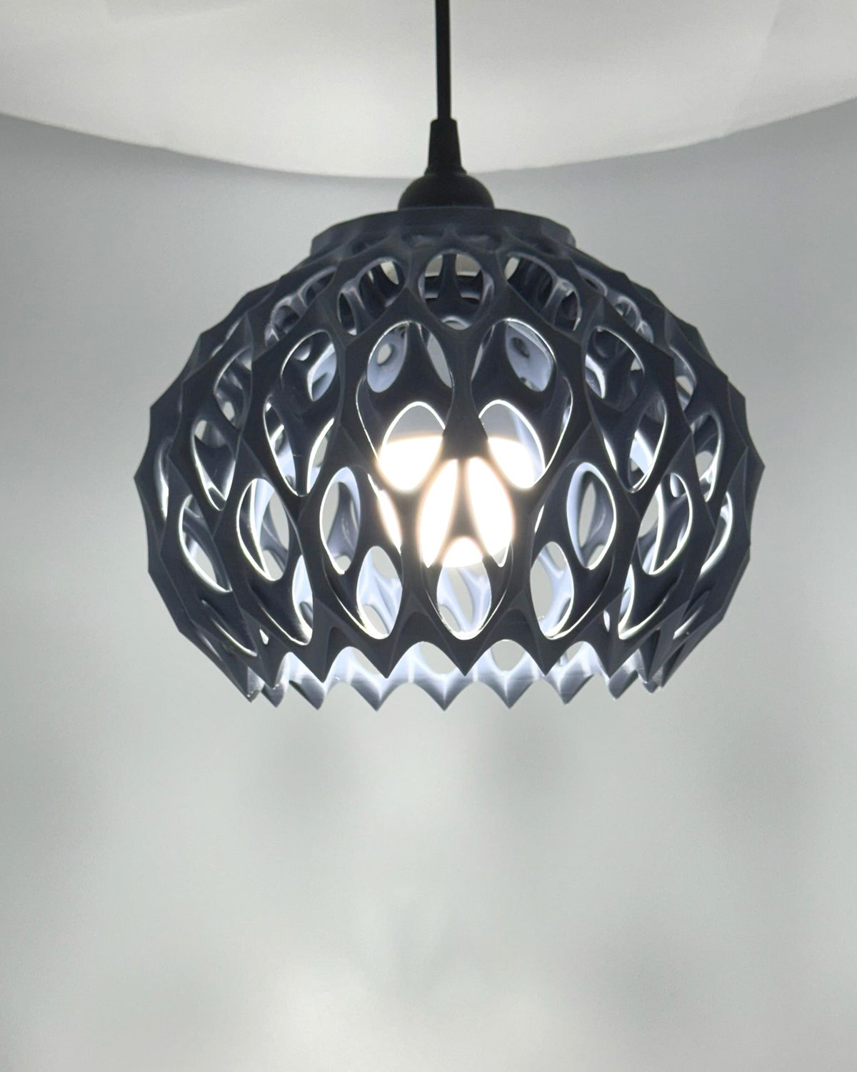 Alien Beehive pendant lamp glowing from a lower angle