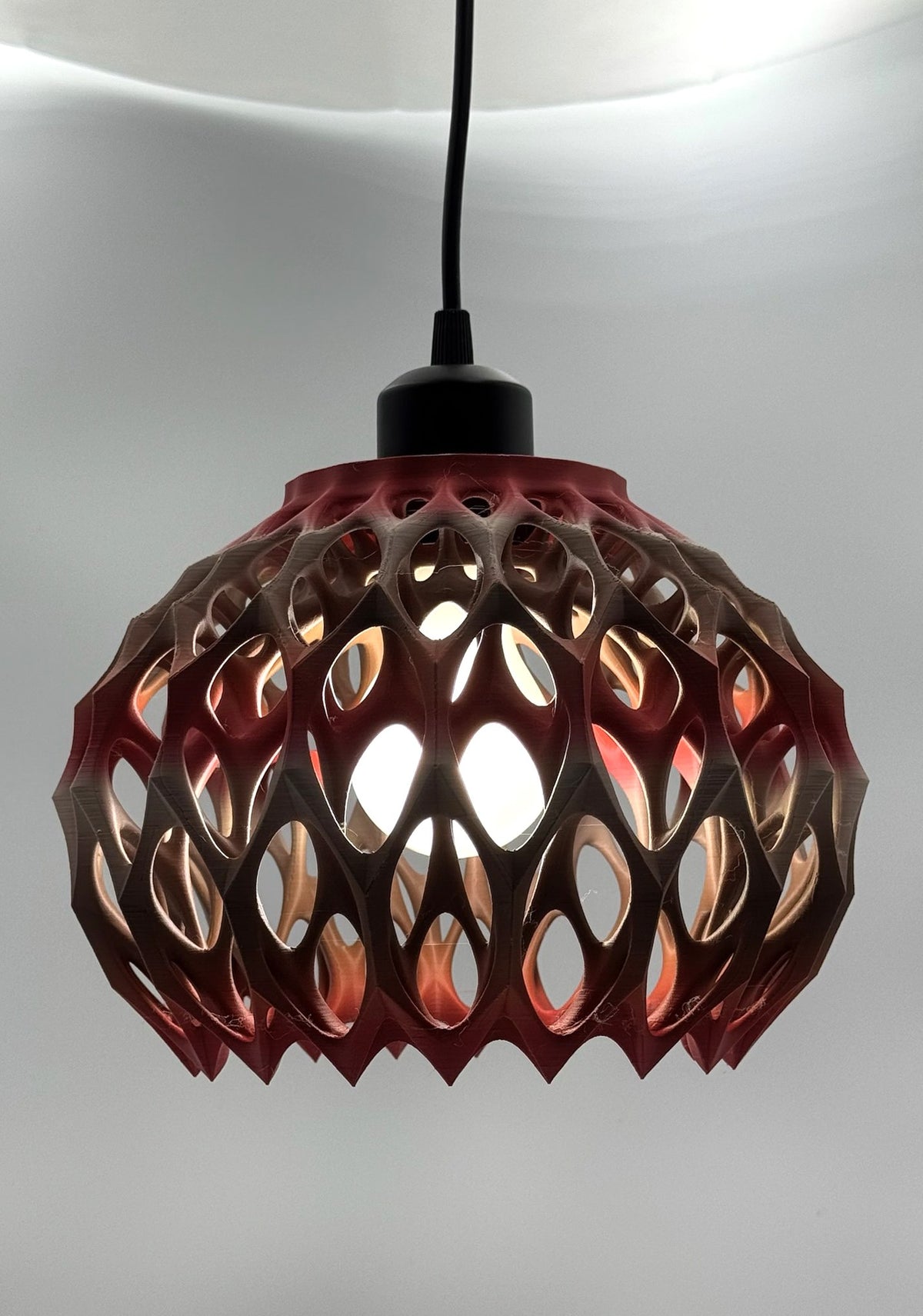 Red to silver metallic Alien Seed Pod 3D printed pendant lamp glowing