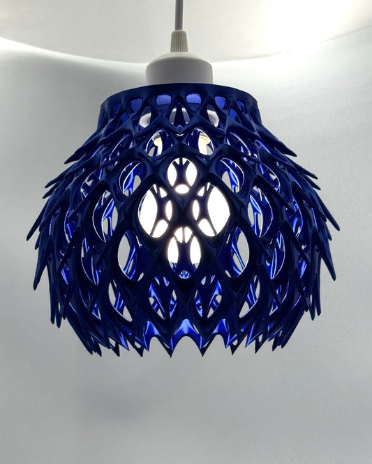Cobalt blue Blue Alien Artichoke 3D printed pendant lamp with spiky petal lattice, glowing
