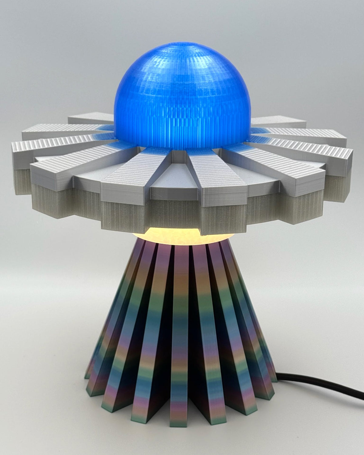 Blue and silver rainbow UFO lamp switched on