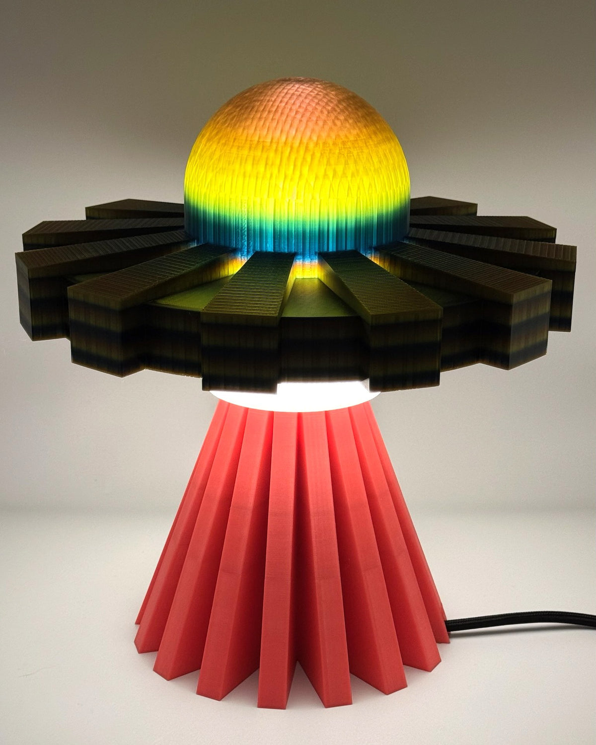 Iridescent metallic UFO lamp glowing gold