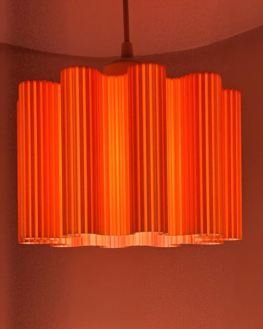 Orange Wave 3D printed pendant lamp glowing bright orange with fluted wave shade