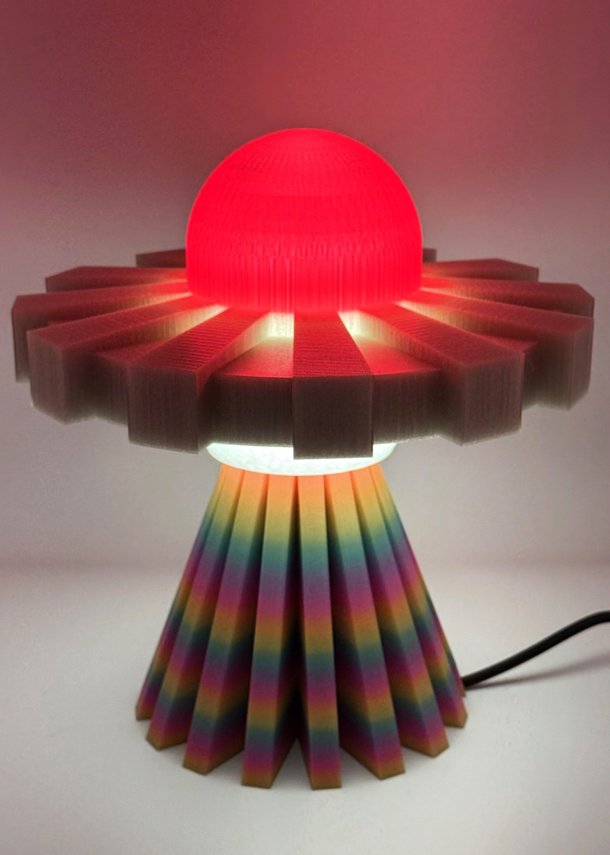 Red and rainbow UFO lamp glowing red