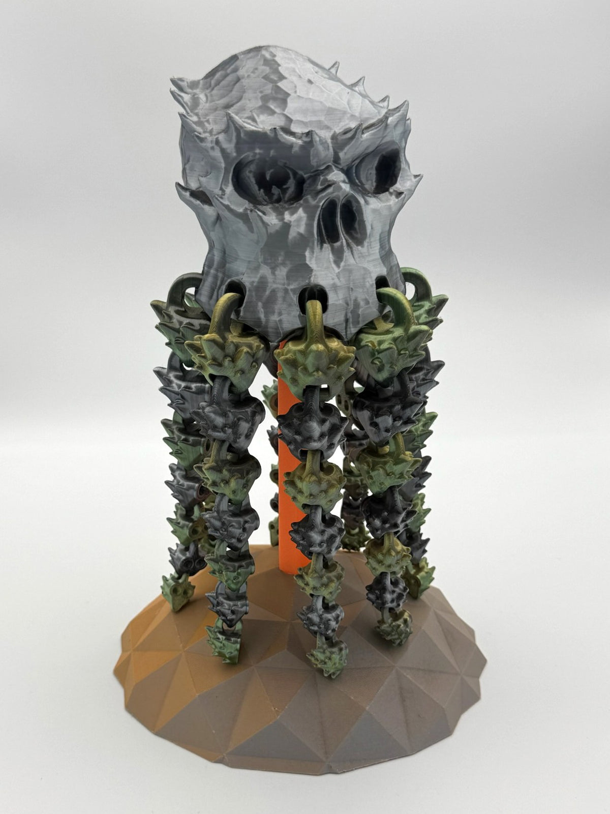 Spookiez Skull 3D printed totem with silver skull and dangling articulated green limbs