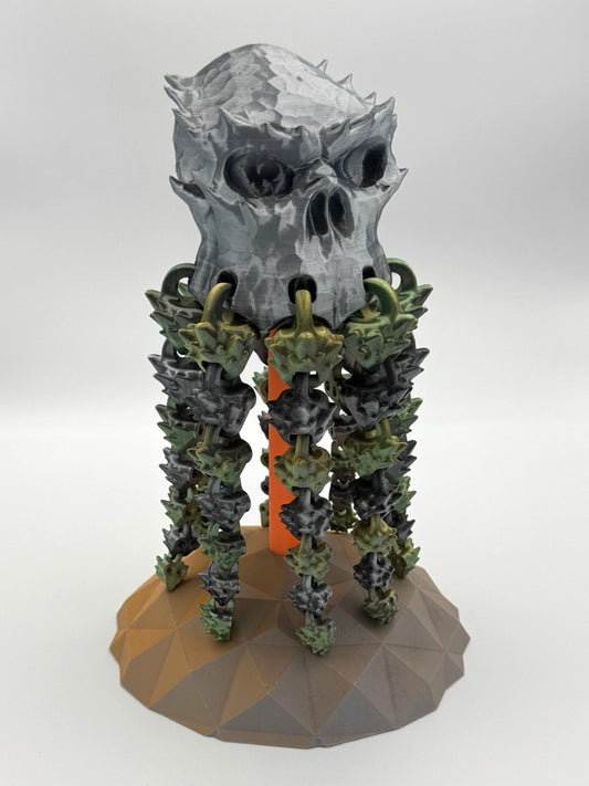 Spookiez Skull 3D printed totem with silver skull and dangling articulated green limbs
