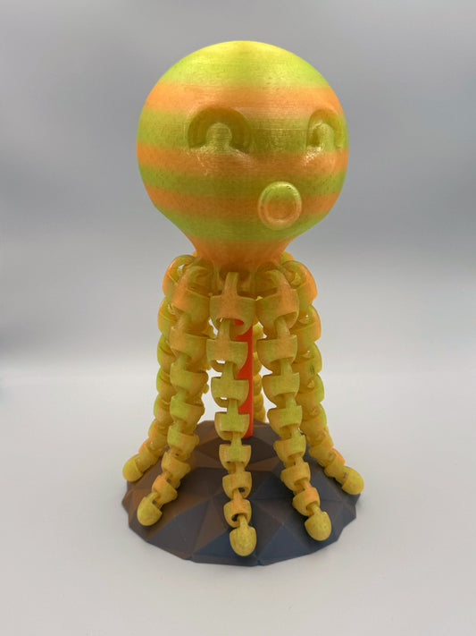 Striped yellow and orange Kraken 3D printed octopus totem on stand