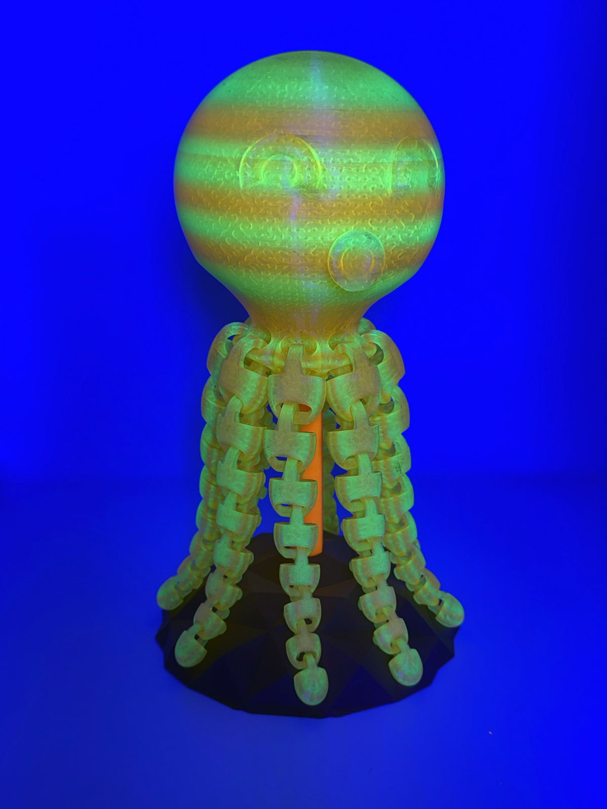 Striped Kraken totem glowing green under blacklight