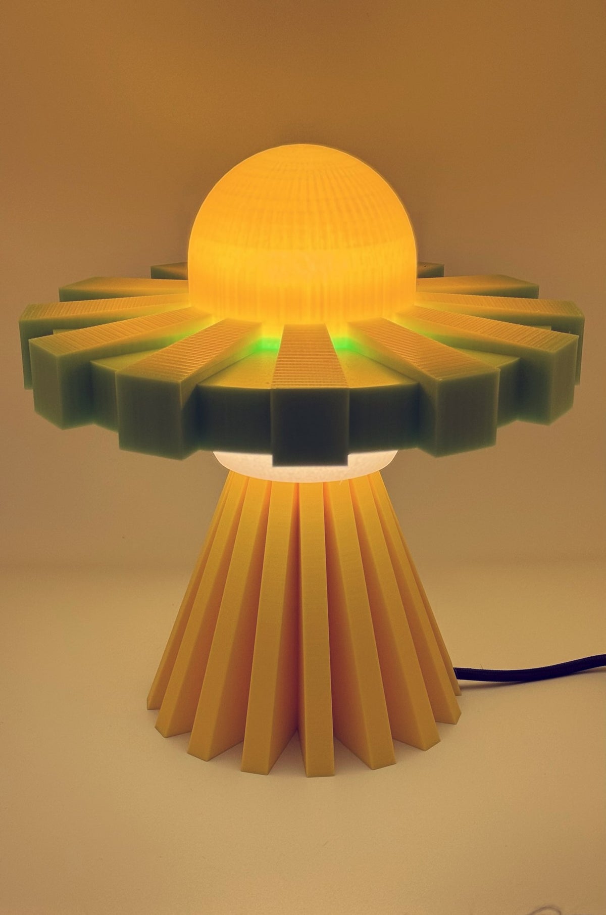 Yellow and green UFO lamp glowing amber