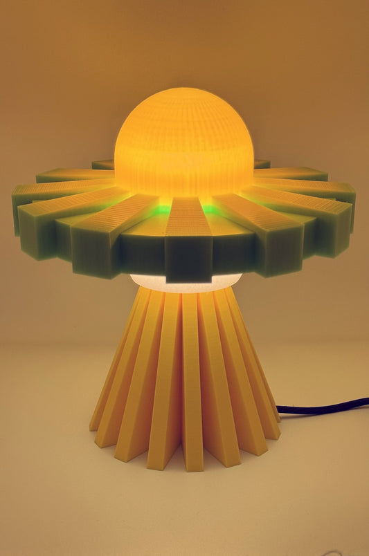 Yellow and green UFO lamp glowing amber