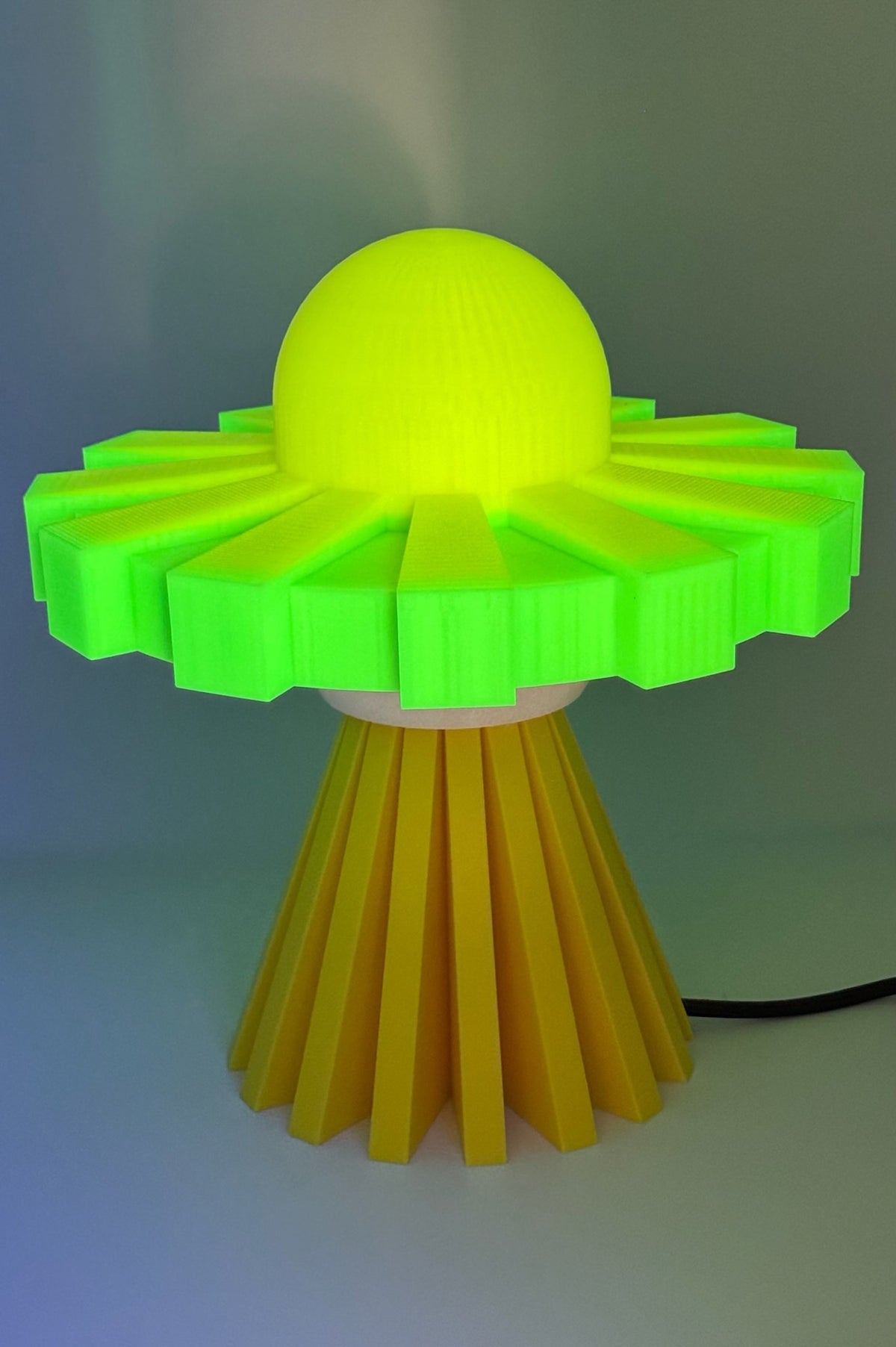 Yellow and green UFO lamp glowing bright yellow
