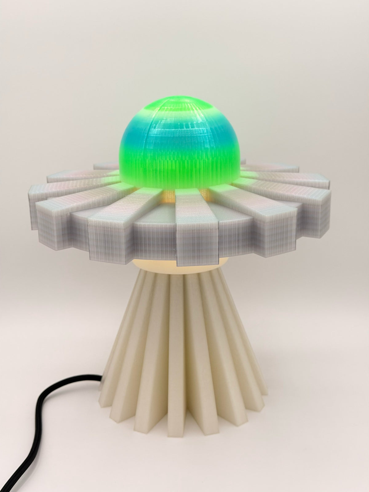 Neon green and silver 3D printed UFO lamp with aqua-to-green dome, translucent silver saucer and cream pleated base