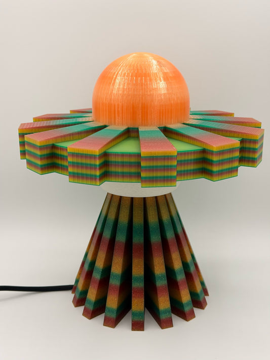 Orange multicolor 3D printed UFO lamp with orange dome, rainbow striped saucer and multicolor striped base