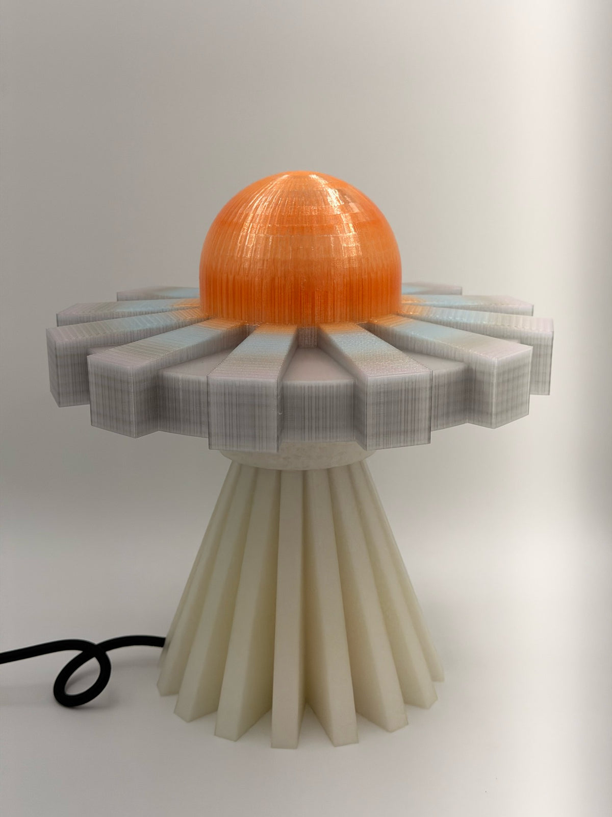 Tangerine and silver UFO lamp from the front, lamp off