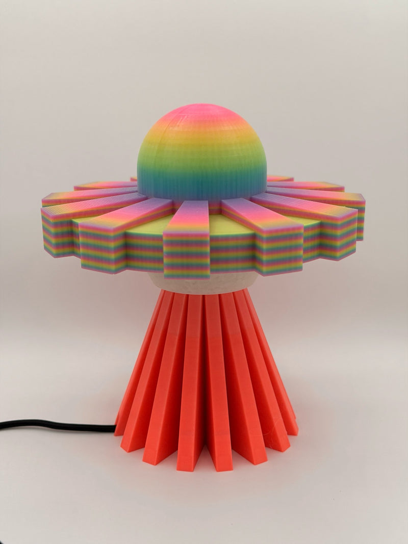 Rainbow and coral red 3D printed UFO lamp with rainbow dome and saucer on a red base