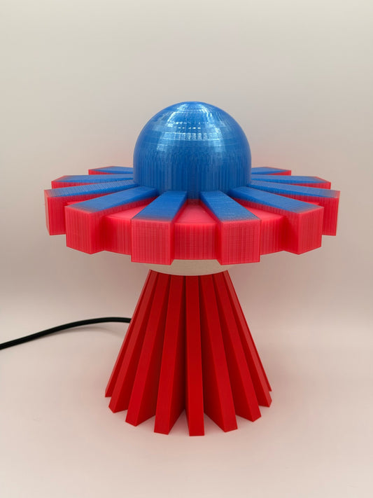 Red and electric blue 3D printed UFO lamp with blue dome, red saucer and red base