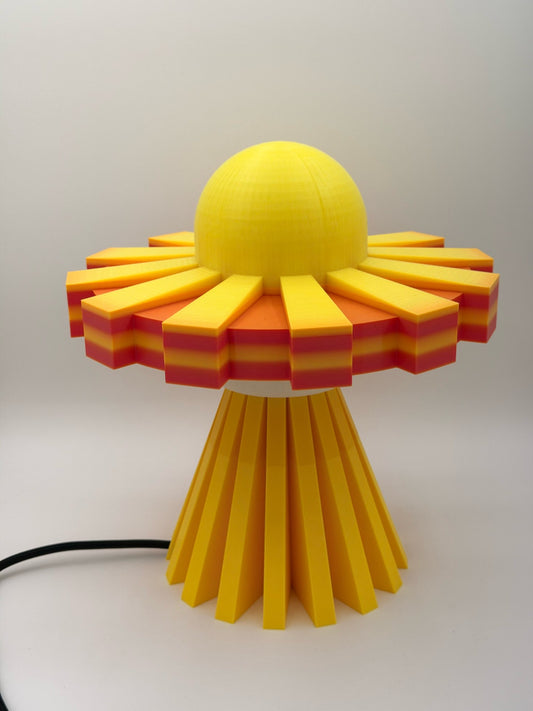 Sunburst yellow and orange 3D printed UFO lamp with yellow dome and orange striped saucer, lamp off