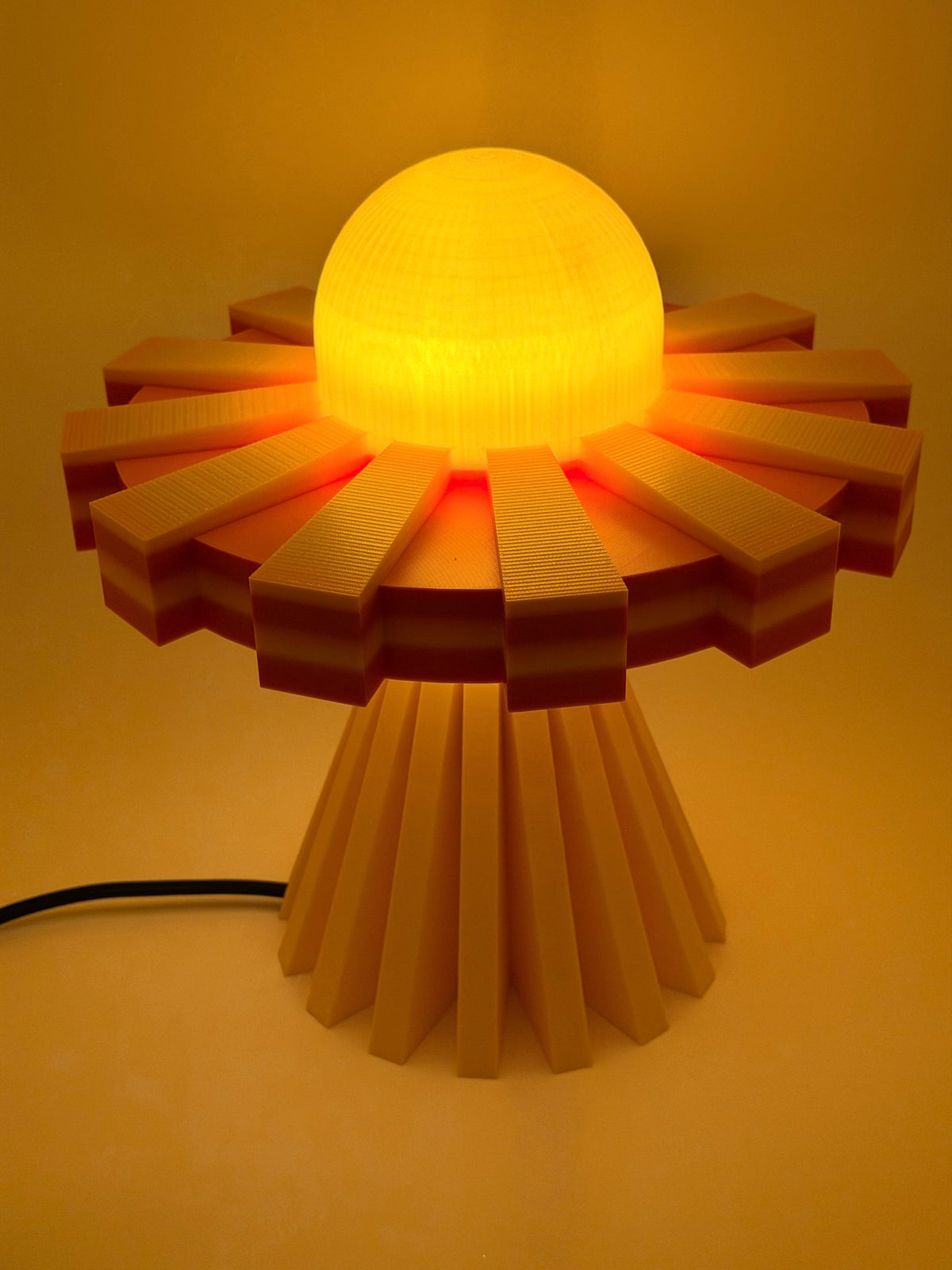 Sunburst UFO lamp glowing in a warm amber room